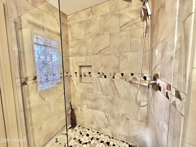 bathroom with a tile shower