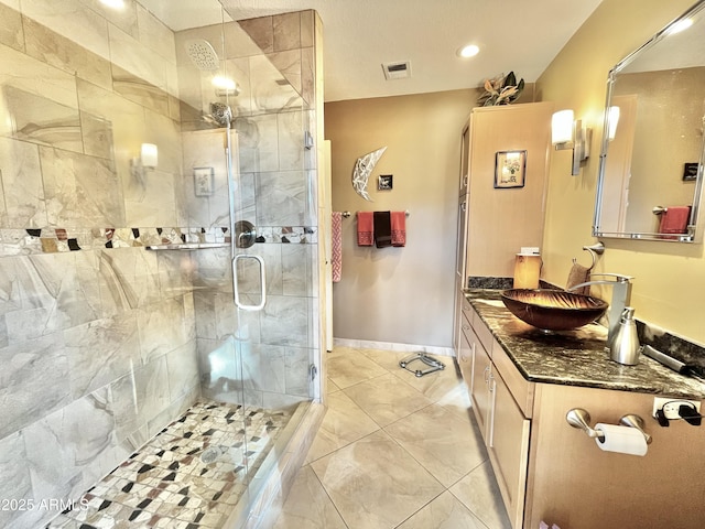 bathroom with vanity, tile patterned flooring, and a shower with door