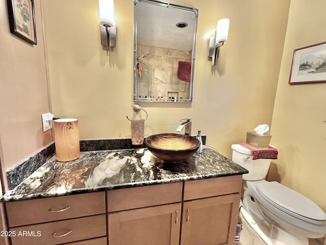 bathroom featuring toilet and vanity