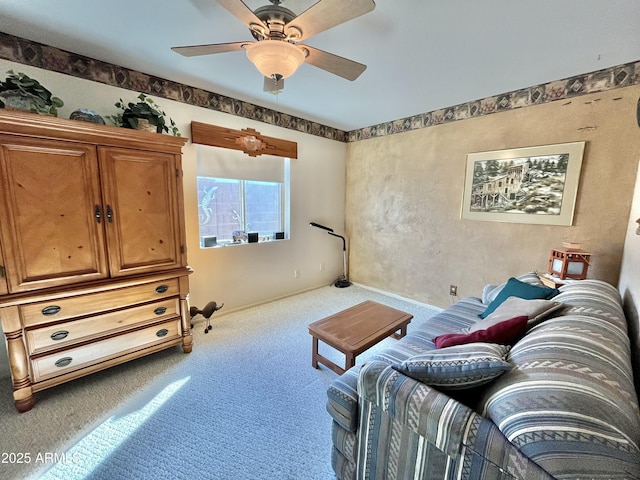 sitting room with ceiling fan and carpet floors