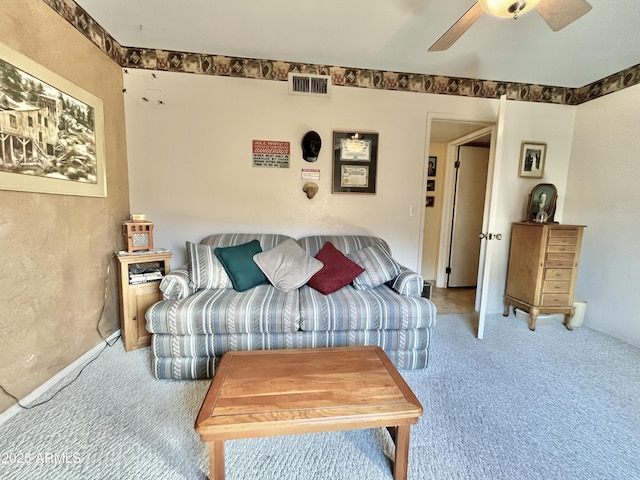 carpeted living room with ceiling fan