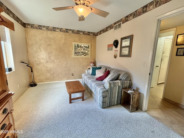 tiled living room with ceiling fan