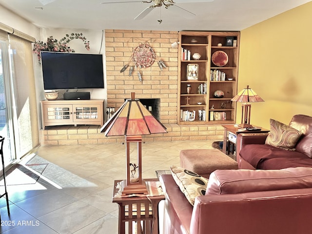 tiled living room with ceiling fan and a brick fireplace