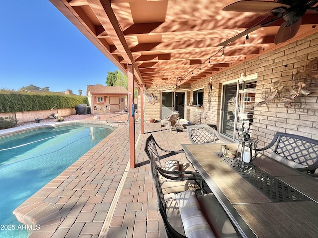 view of swimming pool featuring ceiling fan and a patio