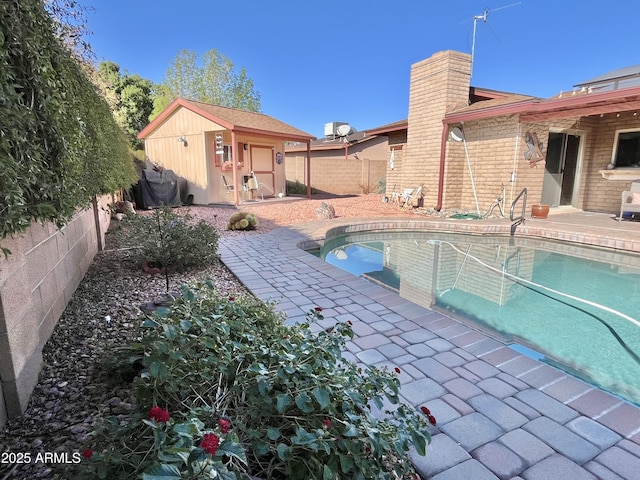 view of pool featuring a patio and an outdoor structure