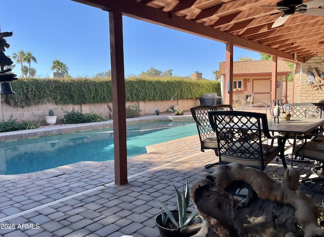 view of swimming pool with ceiling fan and a patio area