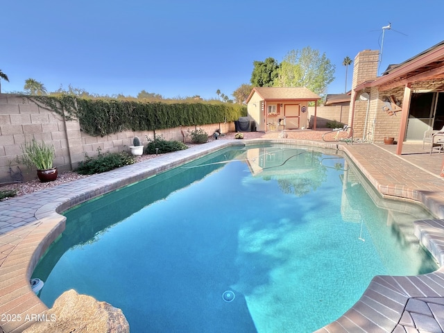 view of pool with an outbuilding