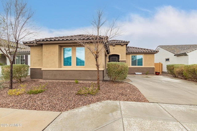 mediterranean / spanish-style home featuring a tile roof and stucco siding