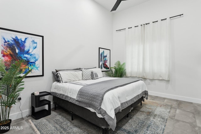 bedroom featuring baseboards and a high ceiling
