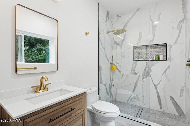 bathroom featuring vanity, toilet, and a marble finish shower