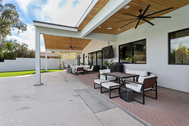 view of patio / terrace with fence, ceiling fan, outdoor lounge area, and outdoor dining area