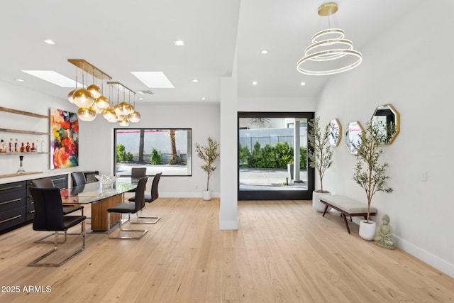 office with an inviting chandelier, a wealth of natural light, and a skylight