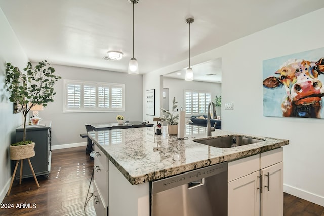 kitchen featuring white cabinetry, dishwasher, sink, decorative light fixtures, and a kitchen island with sink