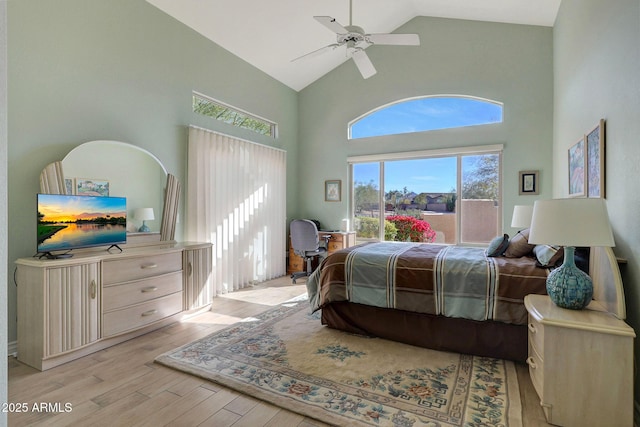 bedroom featuring ceiling fan, light wood-type flooring, and high vaulted ceiling