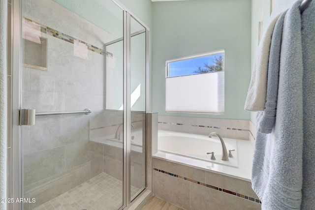 bathroom featuring separate shower and tub