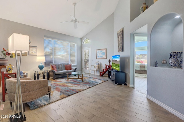 living room featuring ceiling fan and high vaulted ceiling