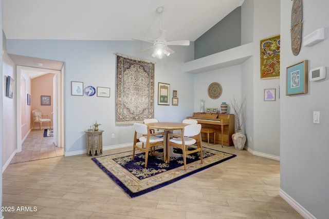 dining space featuring ceiling fan and high vaulted ceiling