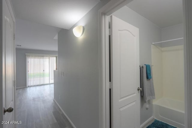 corridor with hardwood / wood-style flooring