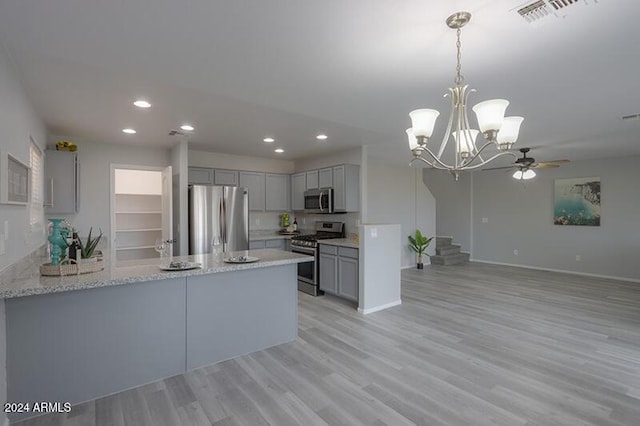 kitchen featuring gray cabinetry, kitchen peninsula, light wood-type flooring, and appliances with stainless steel finishes