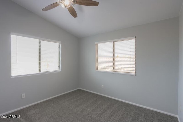 carpeted empty room with ceiling fan and vaulted ceiling