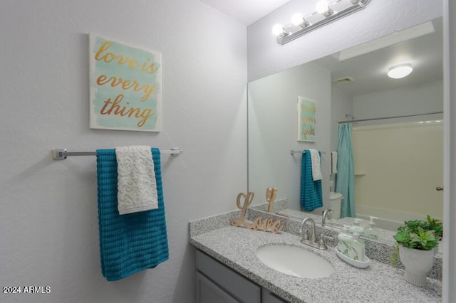 bathroom featuring vanity and curtained shower