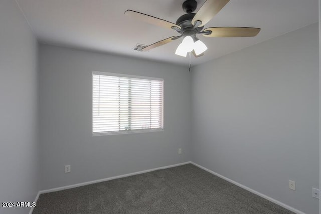 carpeted spare room with ceiling fan