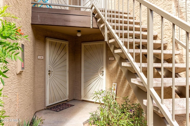 doorway to property featuring stucco siding