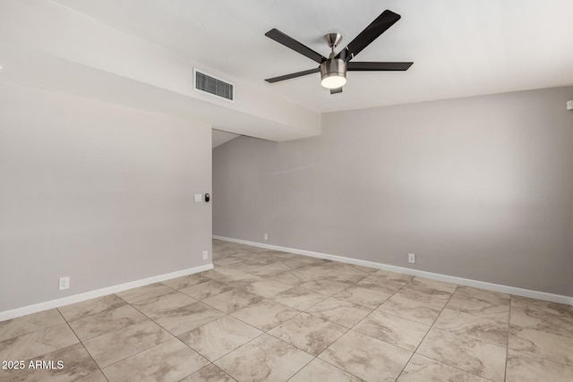 empty room with visible vents, ceiling fan, and baseboards