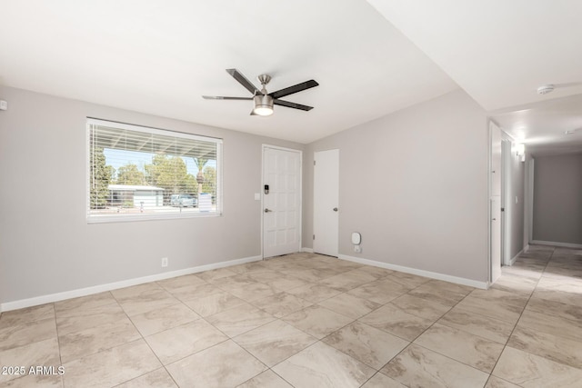 unfurnished room featuring lofted ceiling, ceiling fan, and baseboards