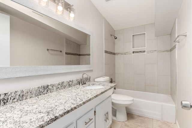 bathroom with tile patterned flooring, bathing tub / shower combination, vanity, and toilet