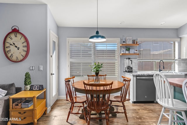 dining space featuring sink and light hardwood / wood-style flooring