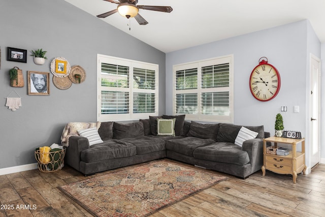 living room with hardwood / wood-style flooring, vaulted ceiling, and ceiling fan