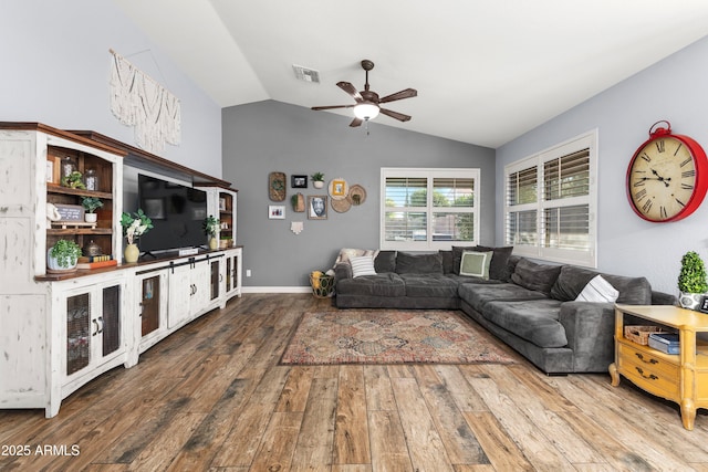 living room with hardwood / wood-style flooring, vaulted ceiling, and ceiling fan