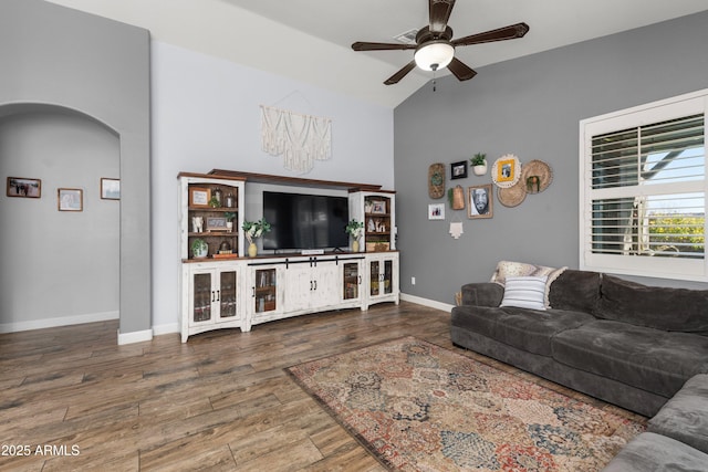 living room featuring ceiling fan, wood-type flooring, and lofted ceiling