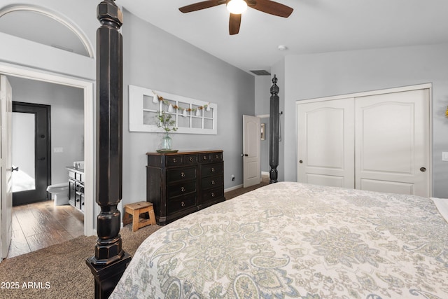 bedroom with hardwood / wood-style flooring, lofted ceiling, ceiling fan, and a closet