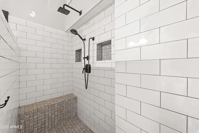 bathroom with a tile shower