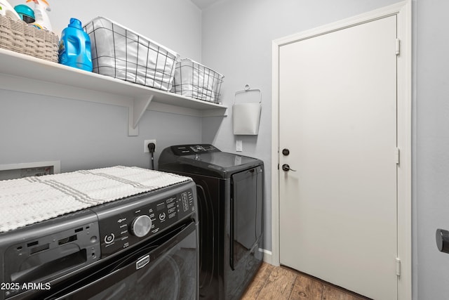 laundry area featuring hardwood / wood-style floors and washer and dryer