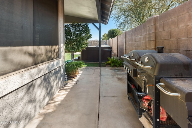 view of patio featuring area for grilling and a hot tub