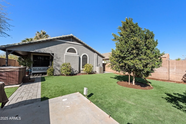 exterior space with central AC, a patio area, and a hot tub