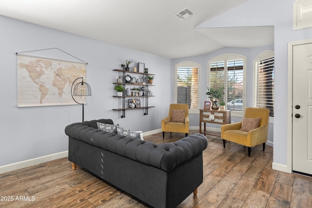 living room with lofted ceiling and hardwood / wood-style floors