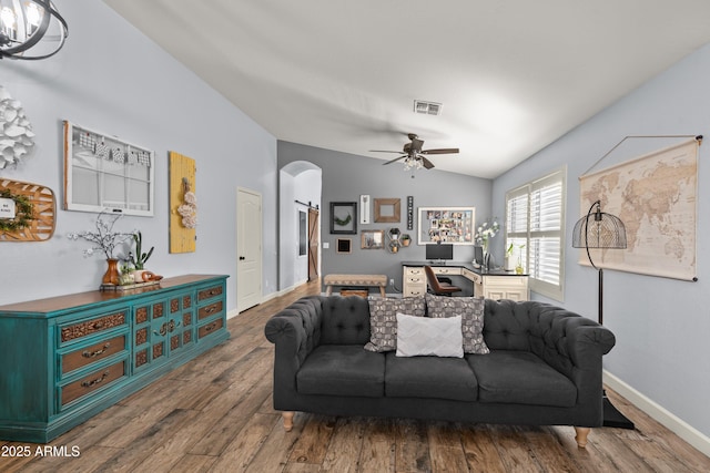 living room with lofted ceiling, hardwood / wood-style floors, and ceiling fan