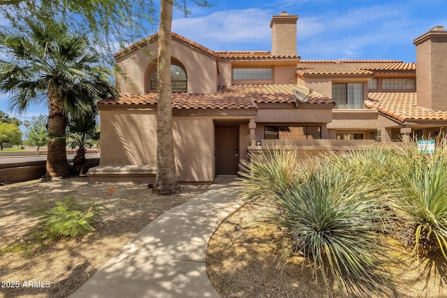 609 E Mesquite Cir Unit D132, Tempe, AZ 85288 - mediterranean / spanish house featuring a chimney and stucco siding