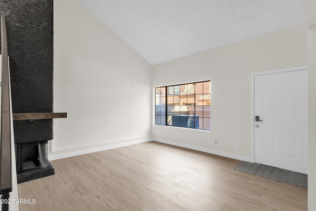 609 E Mesquite Cir Unit D132, Tempe, AZ 85288 - unfurnished living room with wood finished floors, a fireplace, and high vaulted ceiling