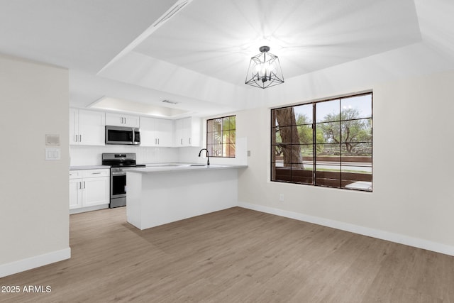 609 E Mesquite Cir Unit D132, Tempe, AZ 85288 - kitchen with appliances with stainless steel finishes, light wood-style flooring, and white cabinets