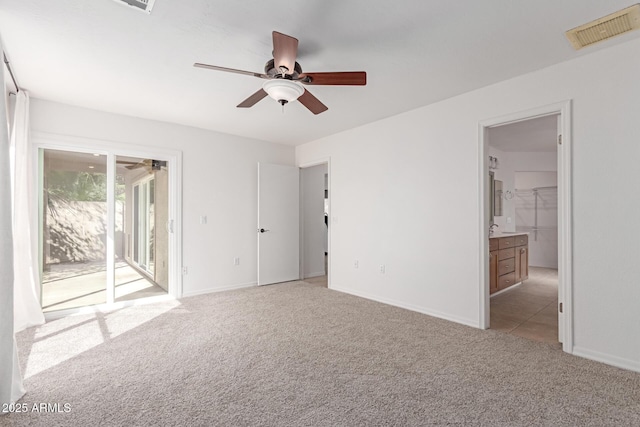 unfurnished bedroom with visible vents, light colored carpet, baseboards, and access to outside