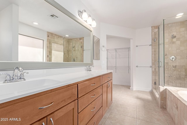 full bathroom with tile patterned floors, a shower stall, and a sink