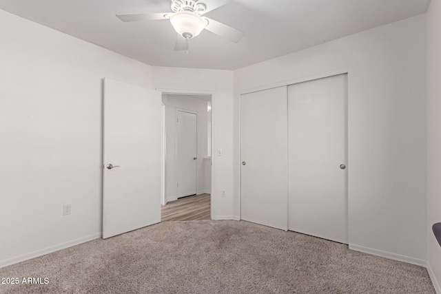 unfurnished bedroom featuring carpet, a closet, and ceiling fan