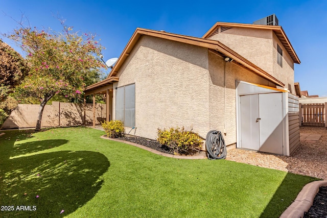 view of side of home with a fenced backyard, a lawn, and stucco siding