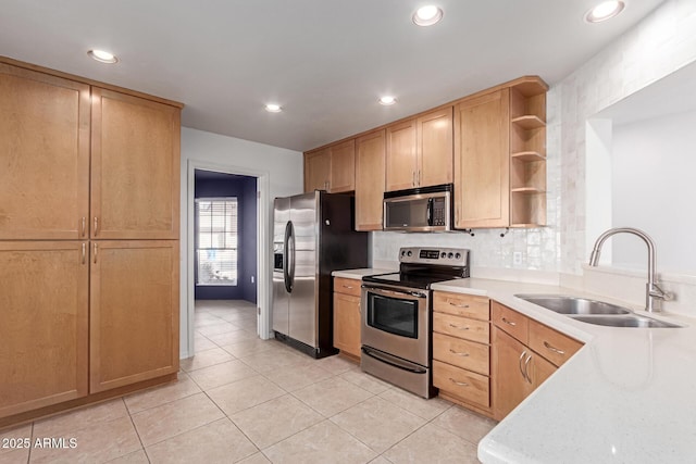 kitchen with a sink, open shelves, light countertops, and stainless steel appliances