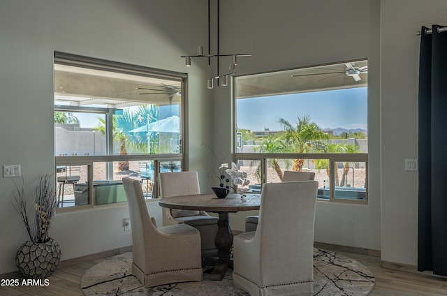 14332 E Bobwhite Way, Scottsdale, AZ 85262 - dining room with a ceiling fan and light wood-type flooring